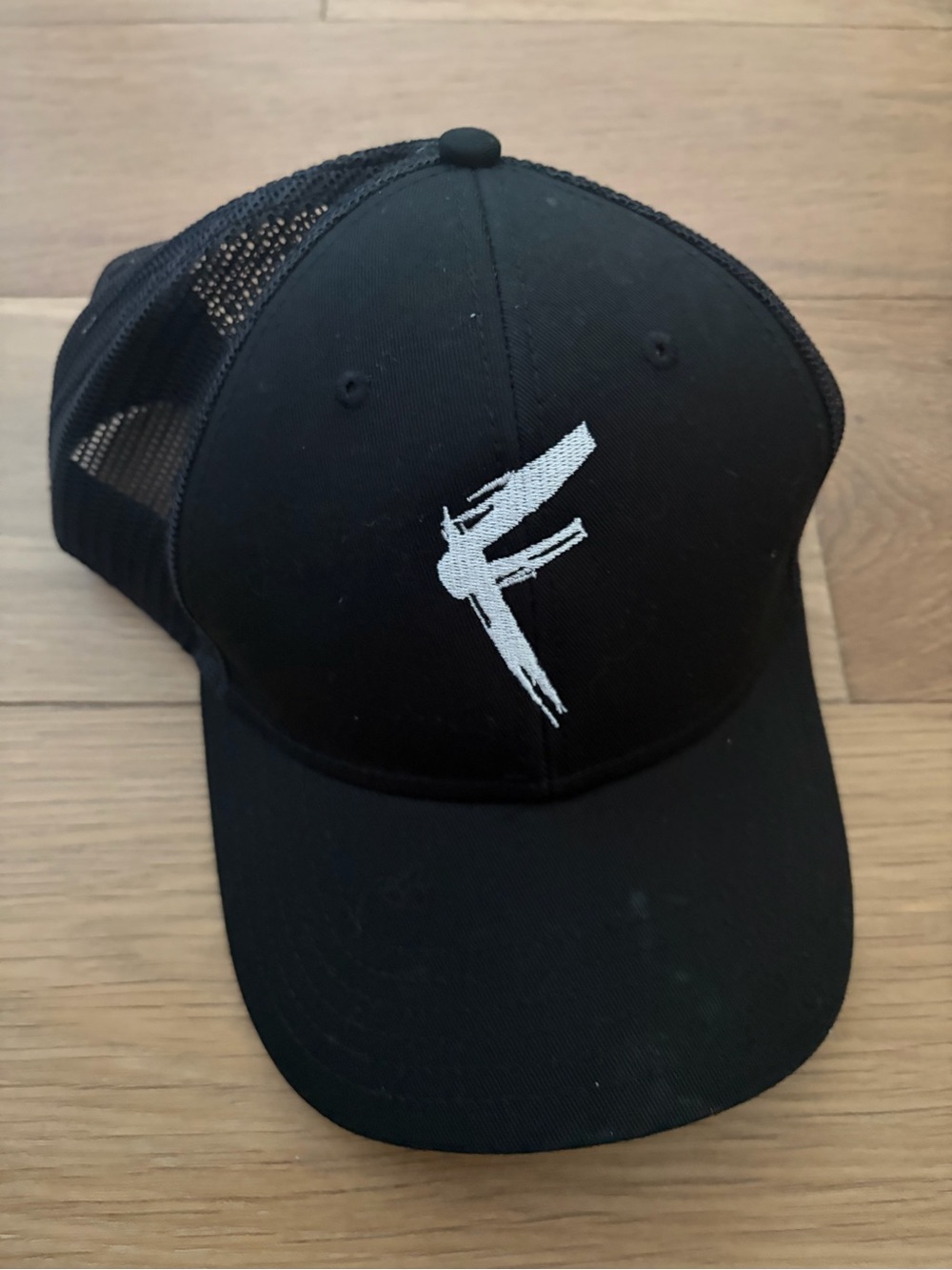 Black Trucker Cap with White Embroidered Bird Logo